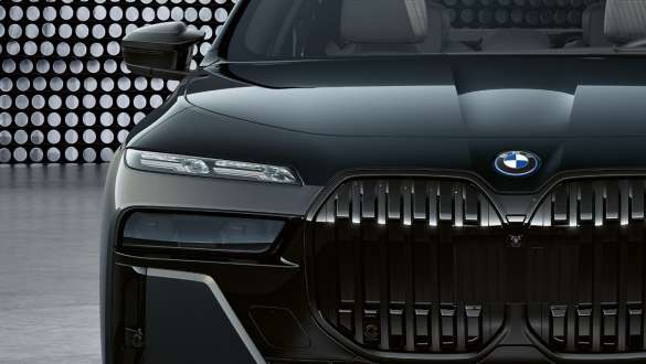 Çarpıcı ön tasarım, BMW M760e xDrive Sedan G70 Motor bölümü kapağı ve M logolu Böbrek Izgaralar, BMW M760e xDrive Sedan G70, BMW Individual Metalik Siyah/Sapphire BMW Individual Metalik Gri/Dravite iki tonlu gövde rengi, yakın plan çekim