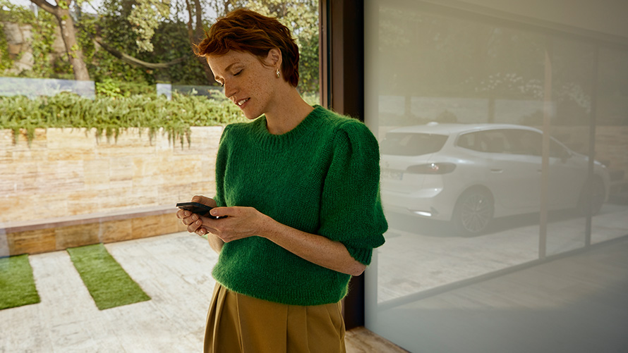 BMW Service Inclusive, akıllı telefon tutan bir kadın Akıllı telefon tutan bir kadın, BMW Service Inclusive