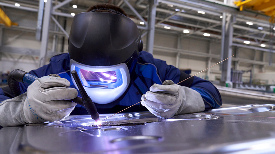 Çalışan koşulları BMW Özel Satışlar Sürdürülebilirlik Merkezi Sosyal BMW Özel Satışlar Sürdürülebilirlik Merkezi Sosyal Çalışan koşulları Koruyucu giysisiyle kaynak yapan kişi